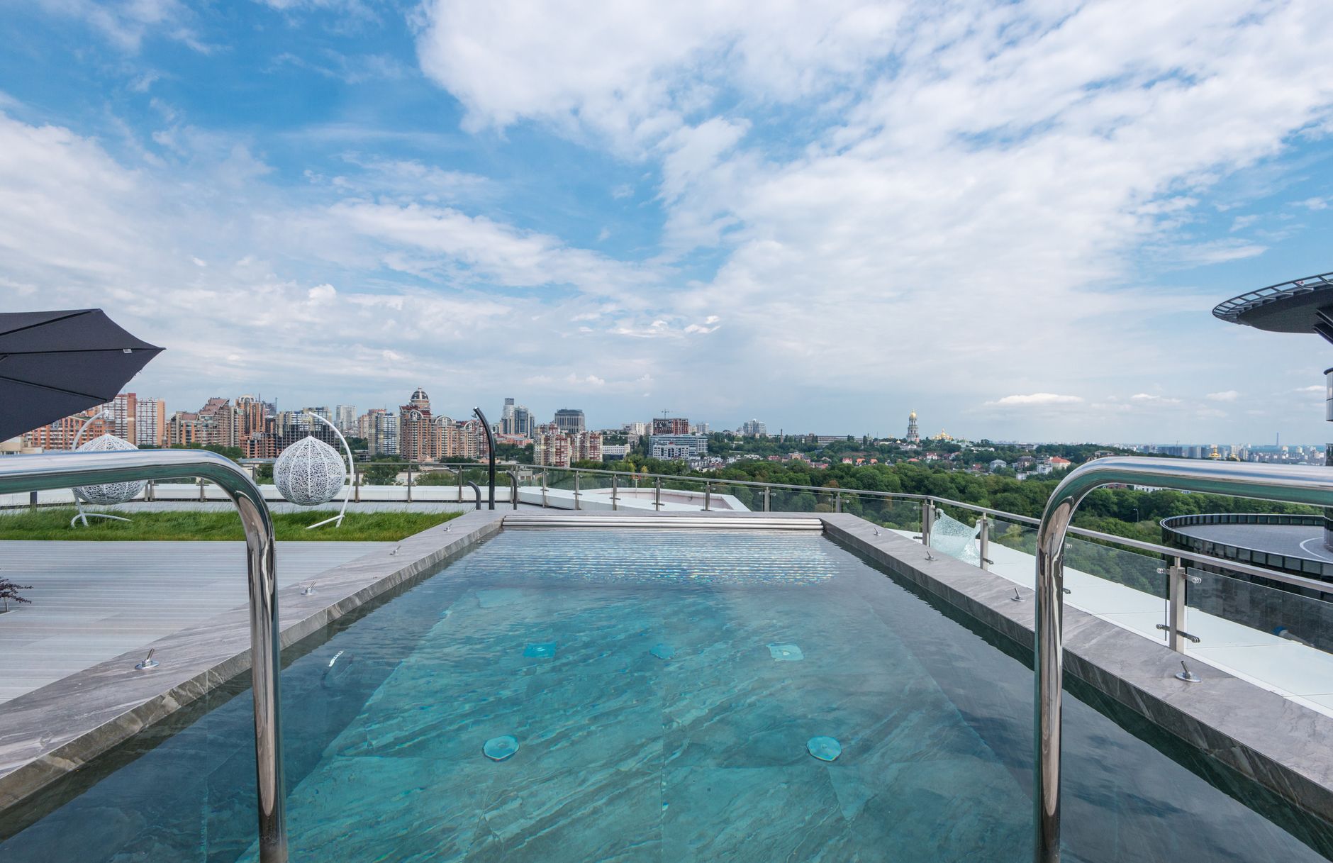 Piscina de borda infinita no terraço de um edifício moderno.